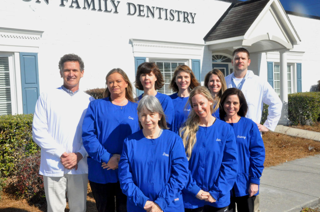 Charleston Family Dentistry team posing in front of their office