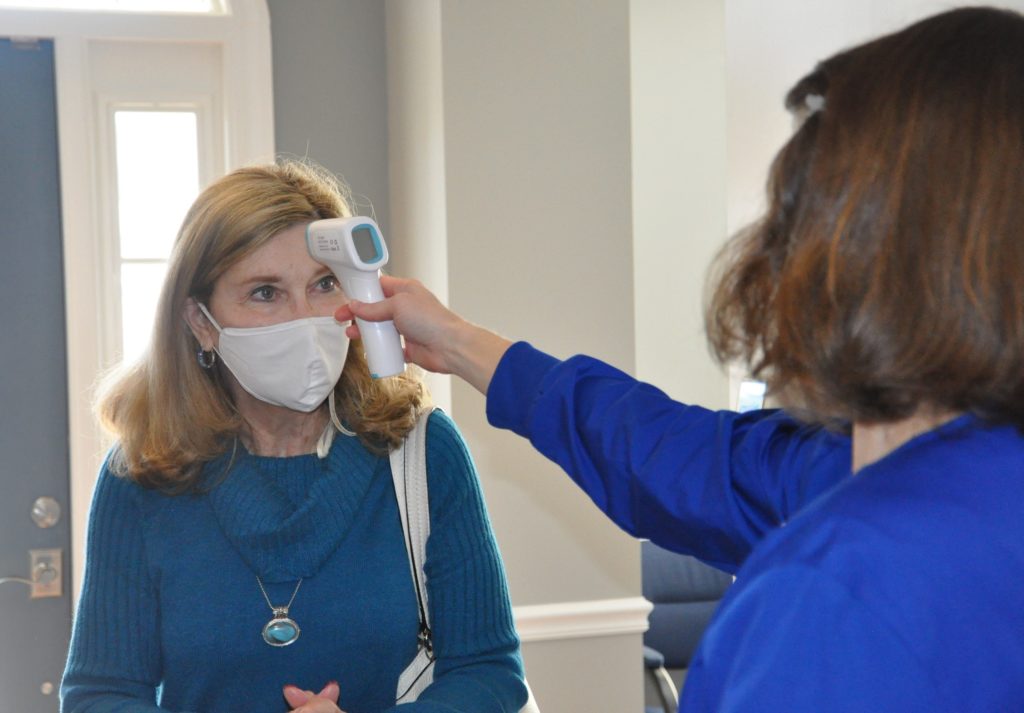 patient receiving a temperature check before entering Charleston Family Dentistry
